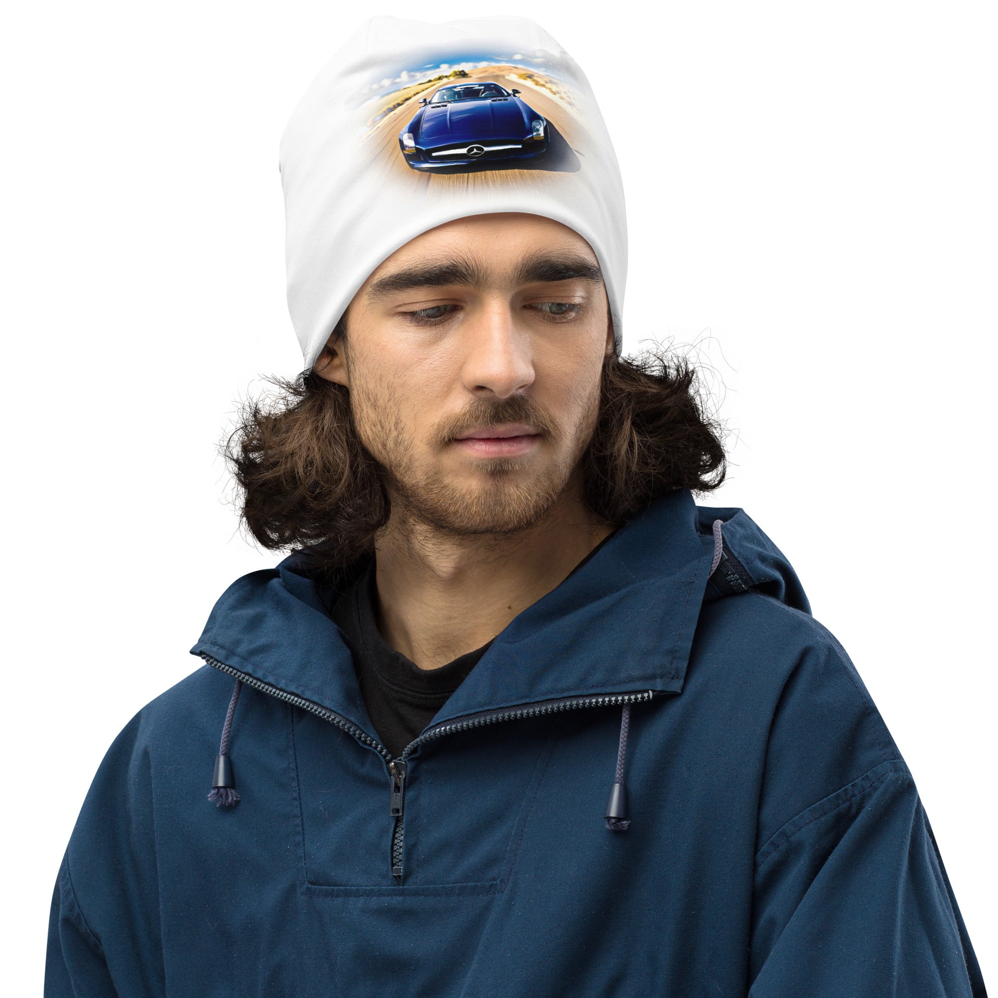 All-over print white beanie with blue car graphic, warm double-layer knit, worn with a navy jacket.