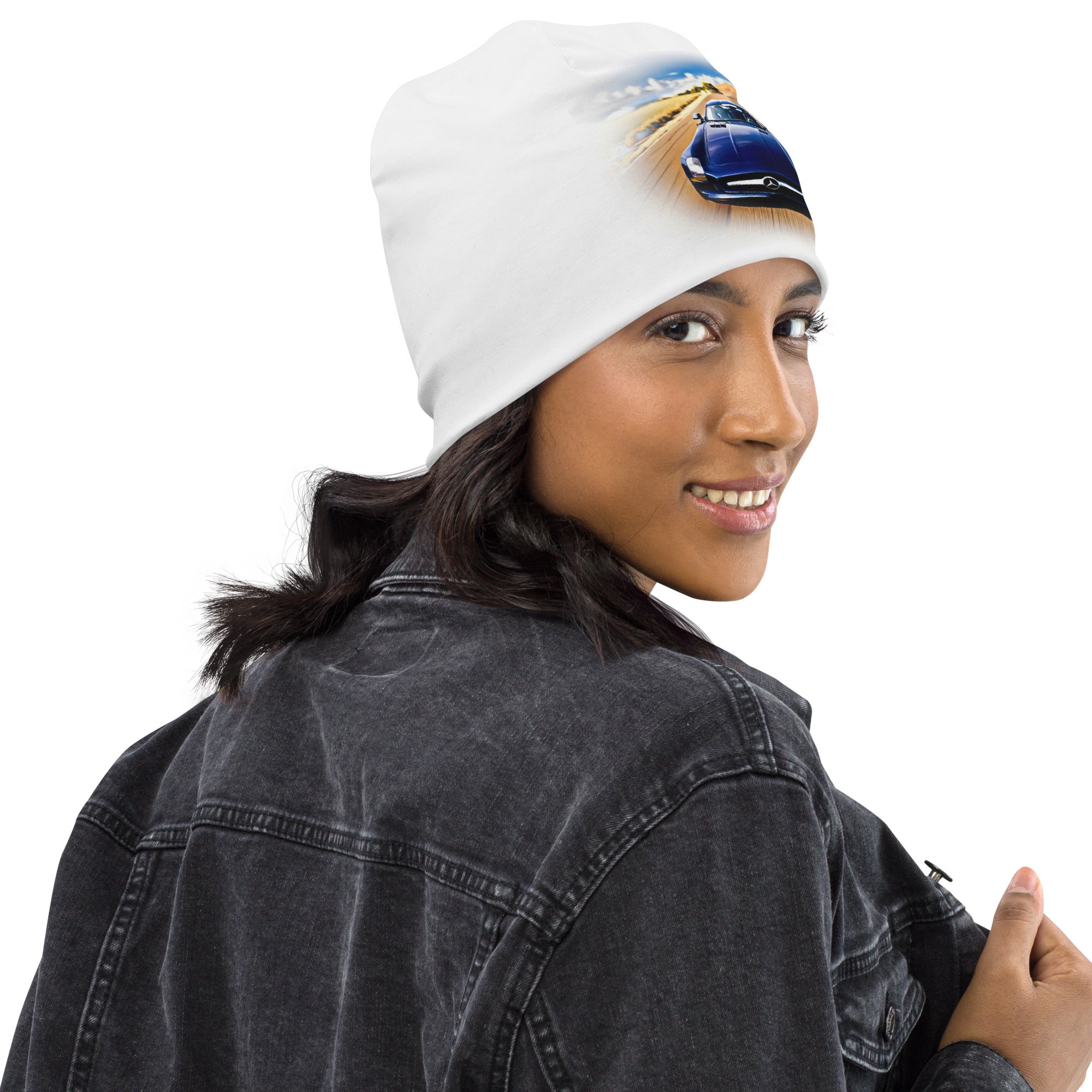 Model wearing white All-Over Print Beanie with blue car graphic; warm, soft double-layer knit.